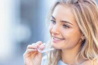 lady holding an invisalign aligner in londond