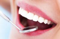 lady smiling while receiving treatment at private dentist